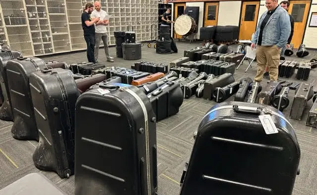 High school band room with music instruments and cases lined up ready for inspection with CutTime.
